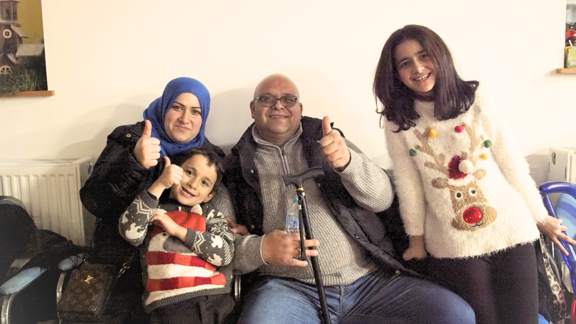 A family photograph of a man, woman and two children.